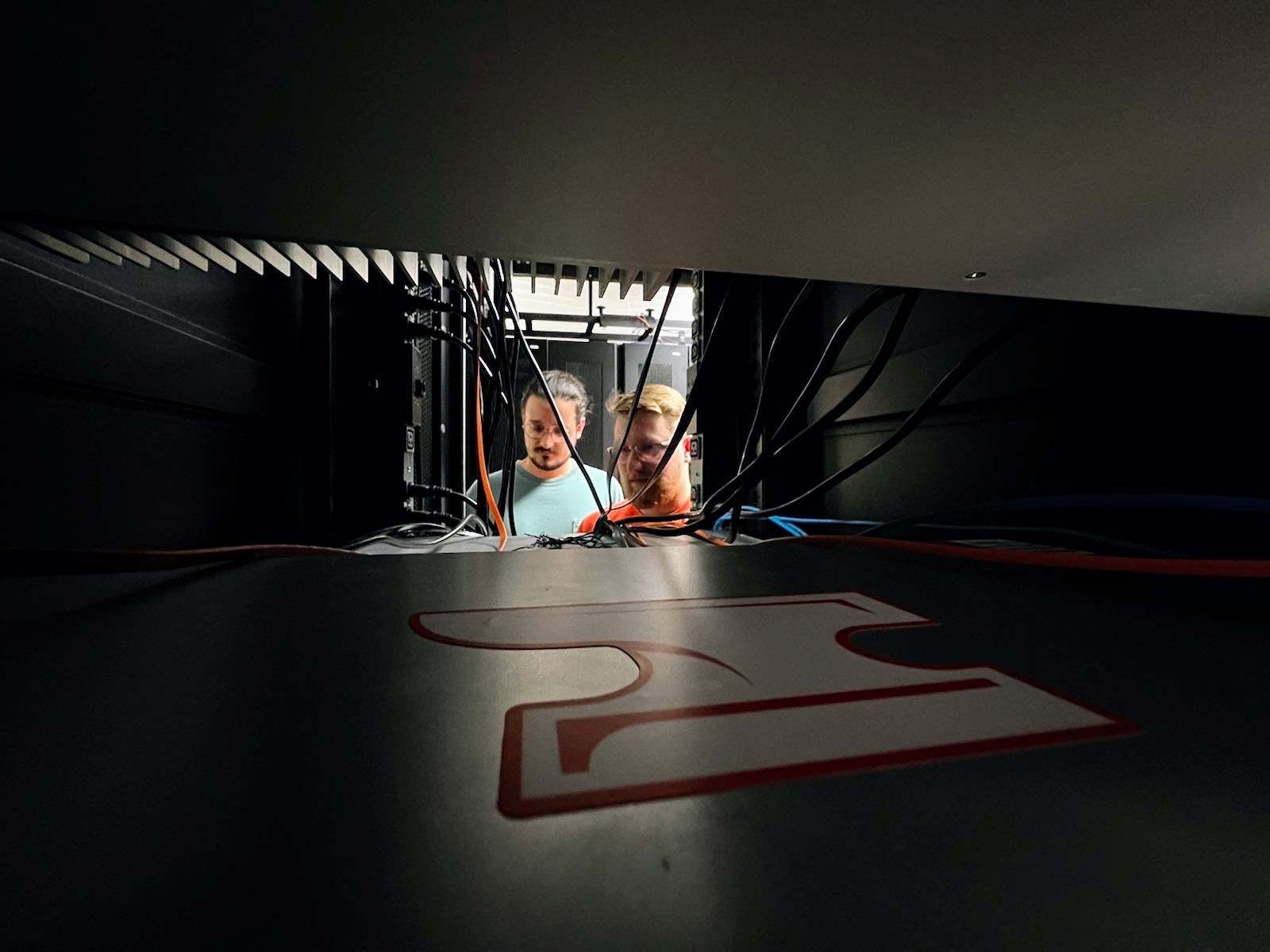 Epoch Forge team working behind server rack cabling