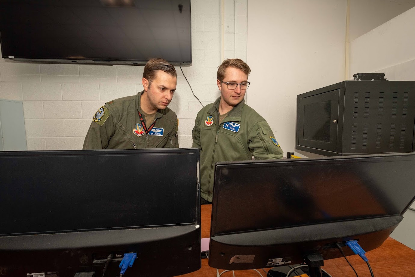 Personnel reviewing mission data as part of AFRL's directed and kinetic energy wargaming experiment.